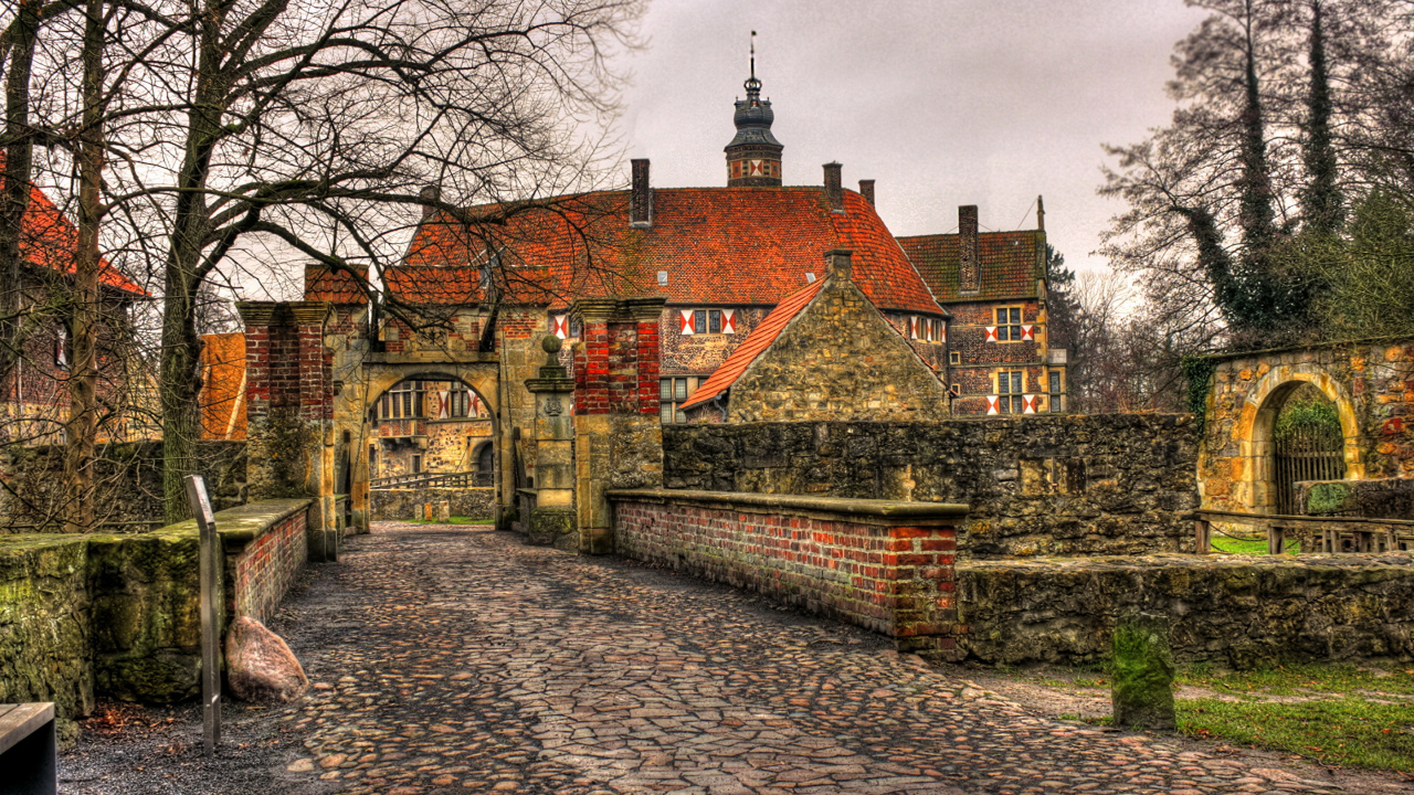 Brown Brick Building Near Bare Trees Under White Clouds During Daytime. Wallpaper in 1280x720 Resolution