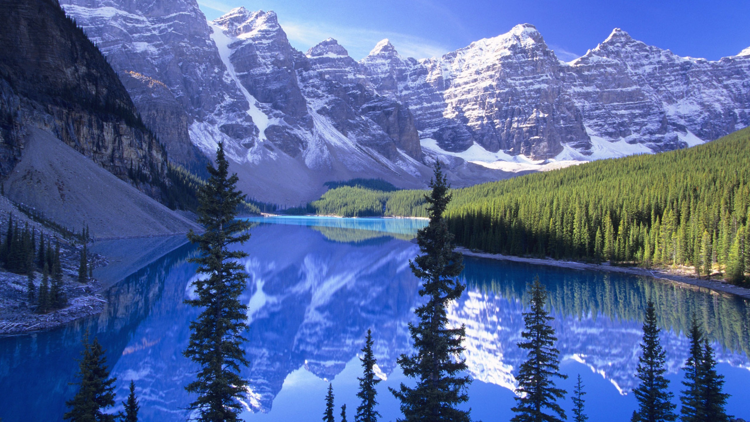 Lake Surrounded by Trees and Snow Covered Mountains During Daytime. Wallpaper in 2560x1440 Resolution