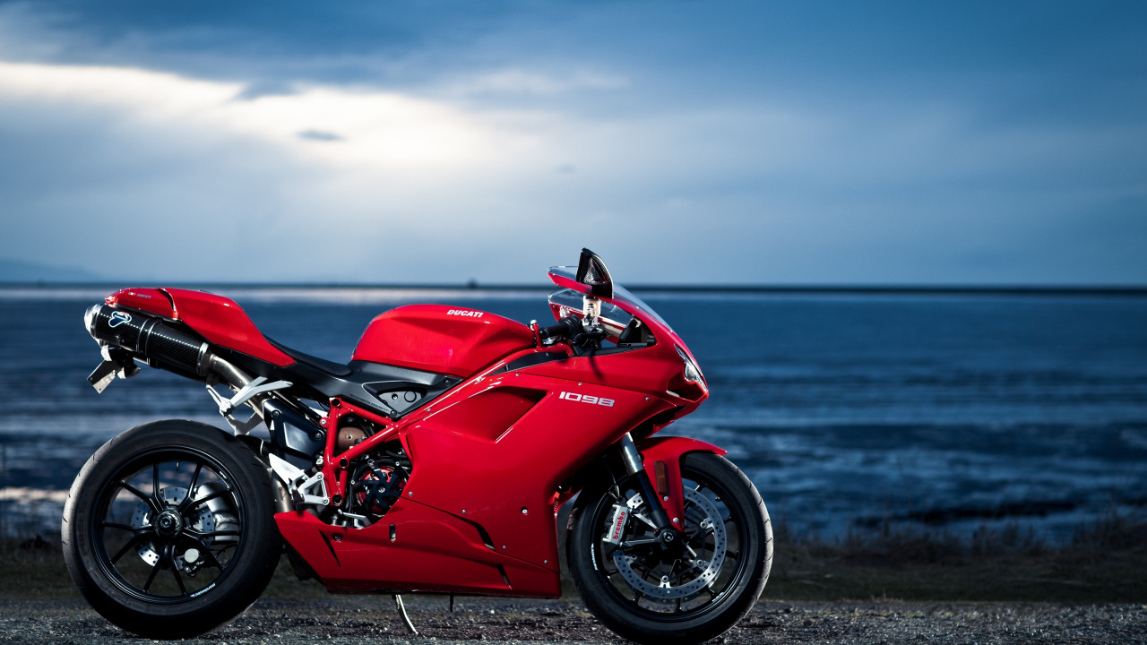 Red and Black Sports Bike Parked on Seashore During Daytime. Wallpaper in 1280x720 Resolution