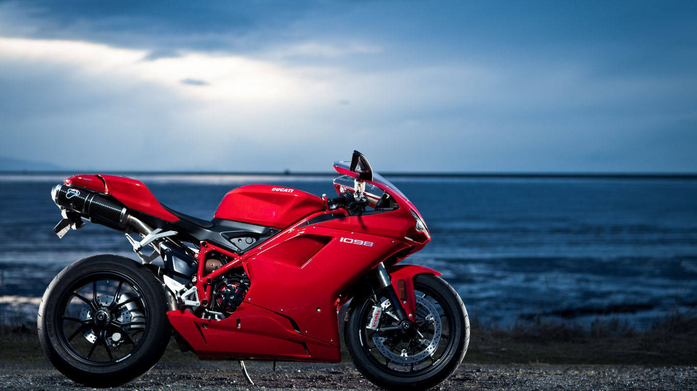 Red and Black Sports Bike Parked on Seashore During Daytime. Wallpaper in 1366x768 Resolution