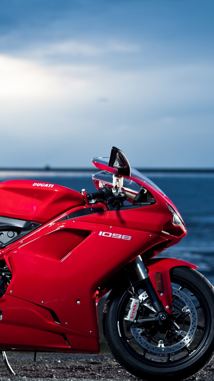 Red and Black Sports Bike Parked on Seashore During Daytime. Wallpaper in 720x1280 Resolution
