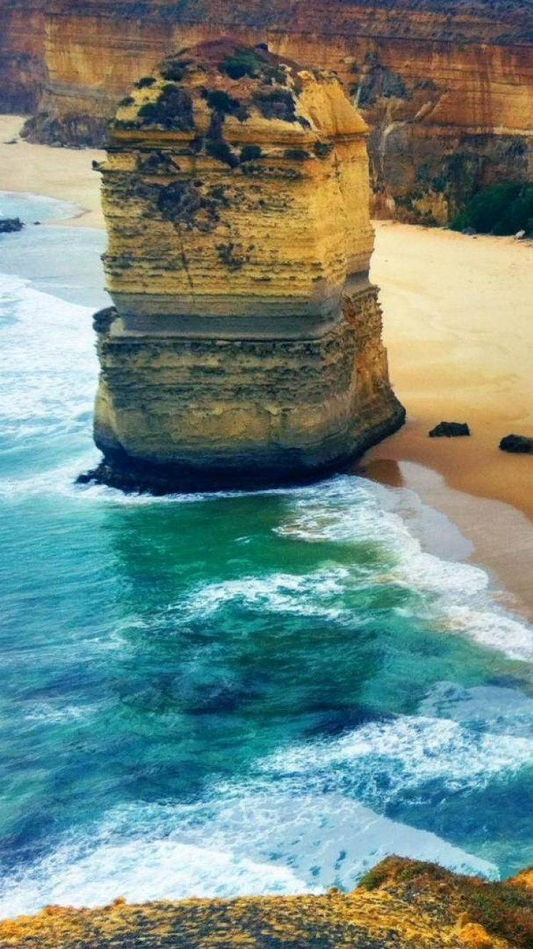 Brown Rock Formation Near Body of Water During Daytime. Wallpaper in 750x1334 Resolution