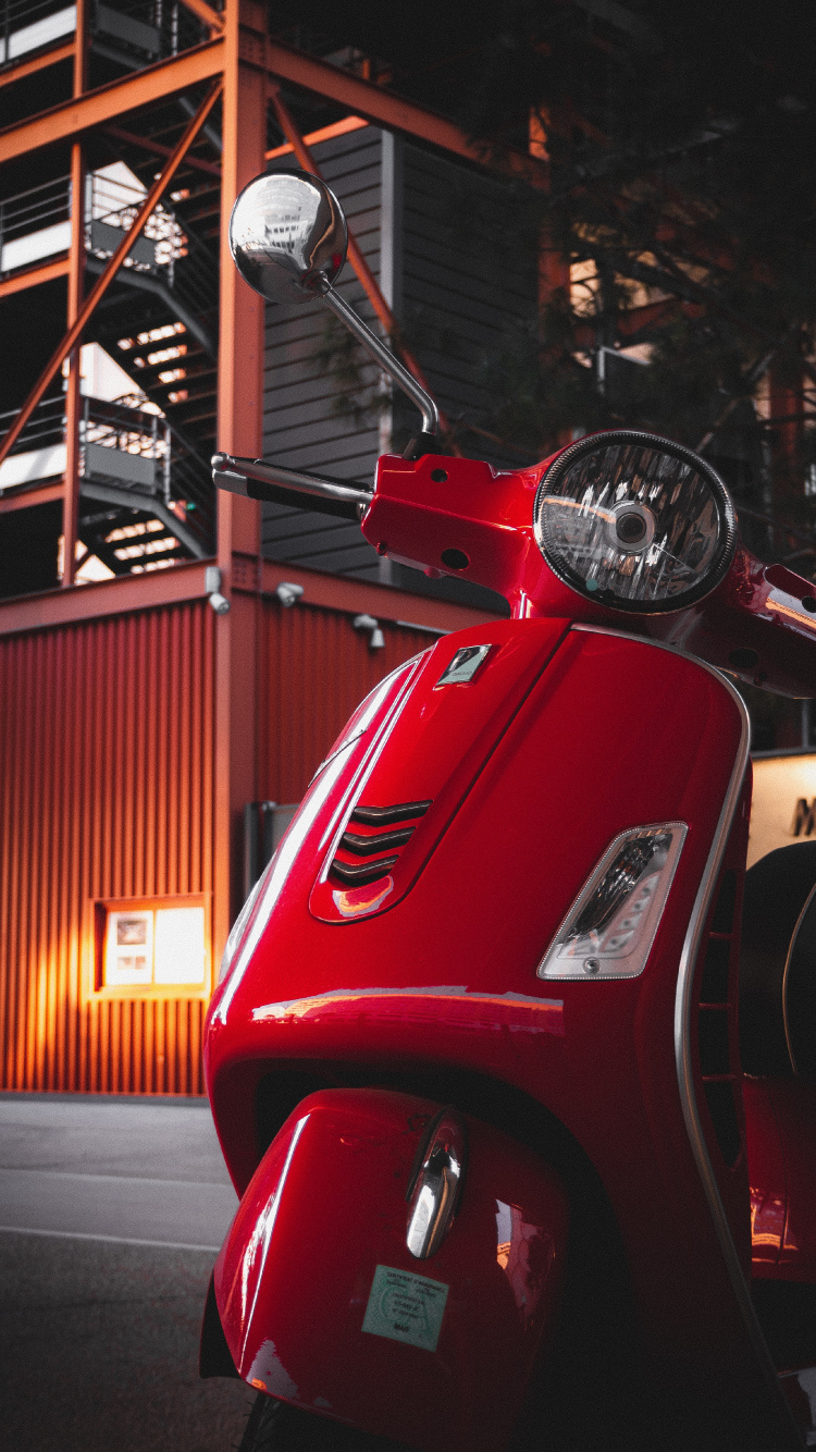 Red Motor Scooter Parked Near Building. Wallpaper in 750x1334 Resolution