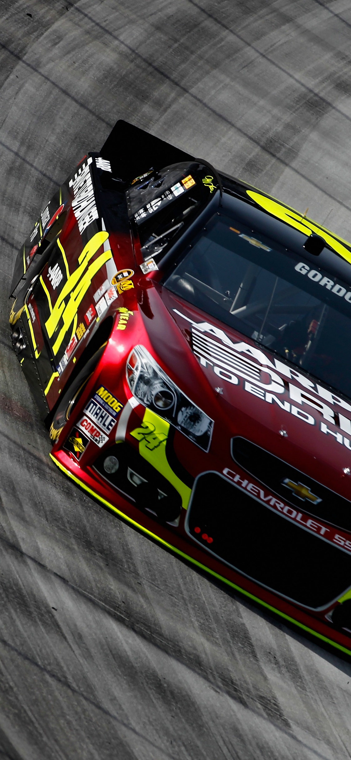 Red and Blue Racing Car on Gray Textile. Wallpaper in 1125x2436 Resolution