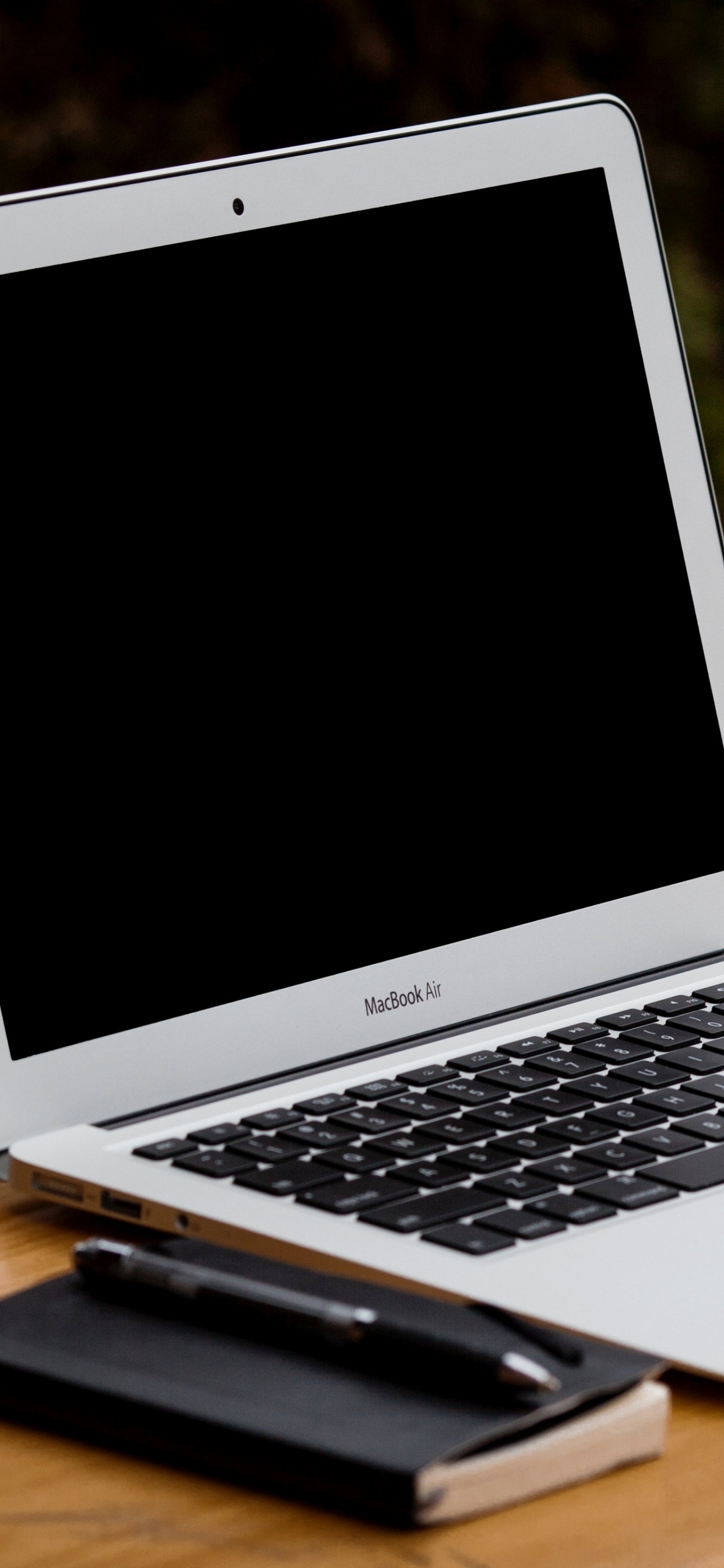 Macbook Air on Brown Wooden Table. Wallpaper in 1242x2688 Resolution