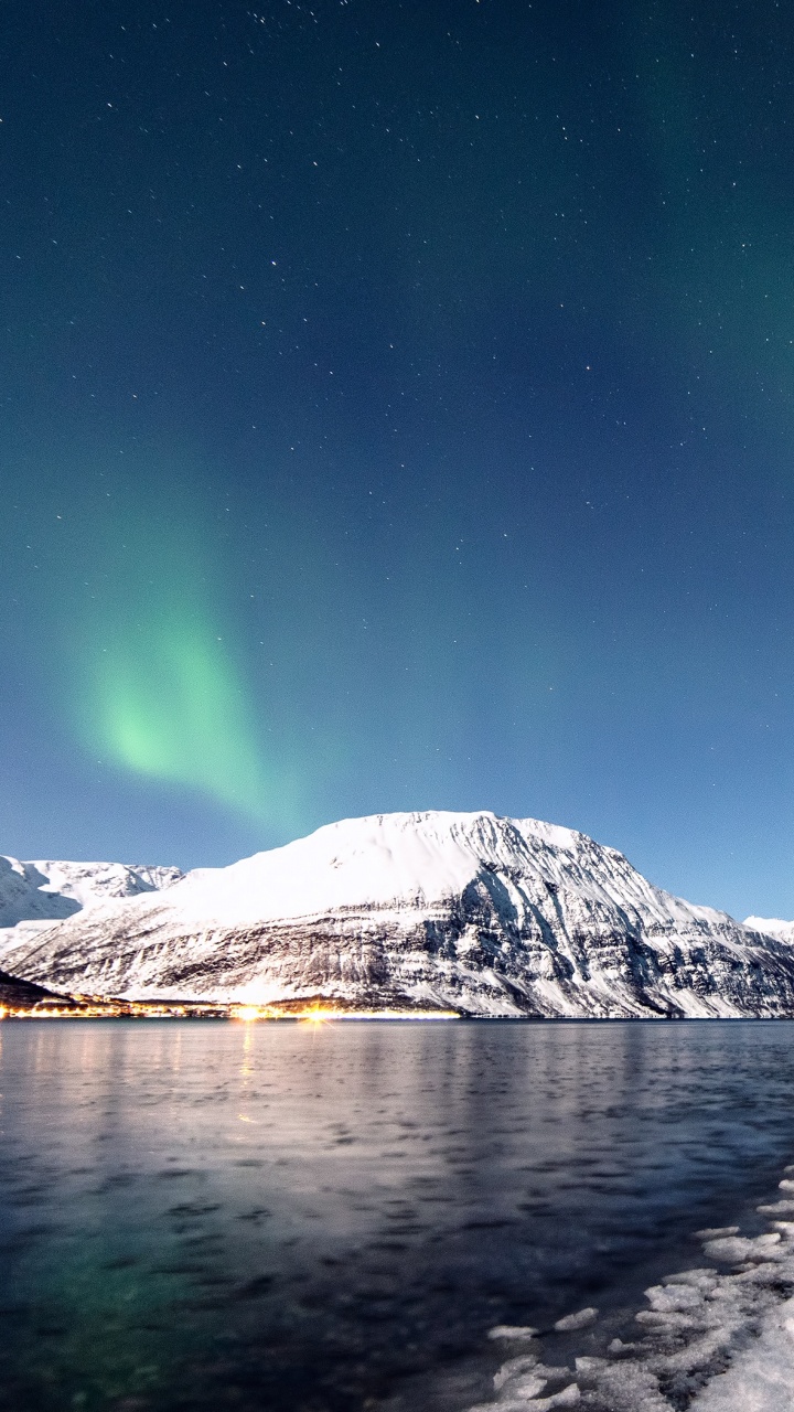 Snow Covered Mountain Near Body of Water During Night Time. Wallpaper in 720x1280 Resolution