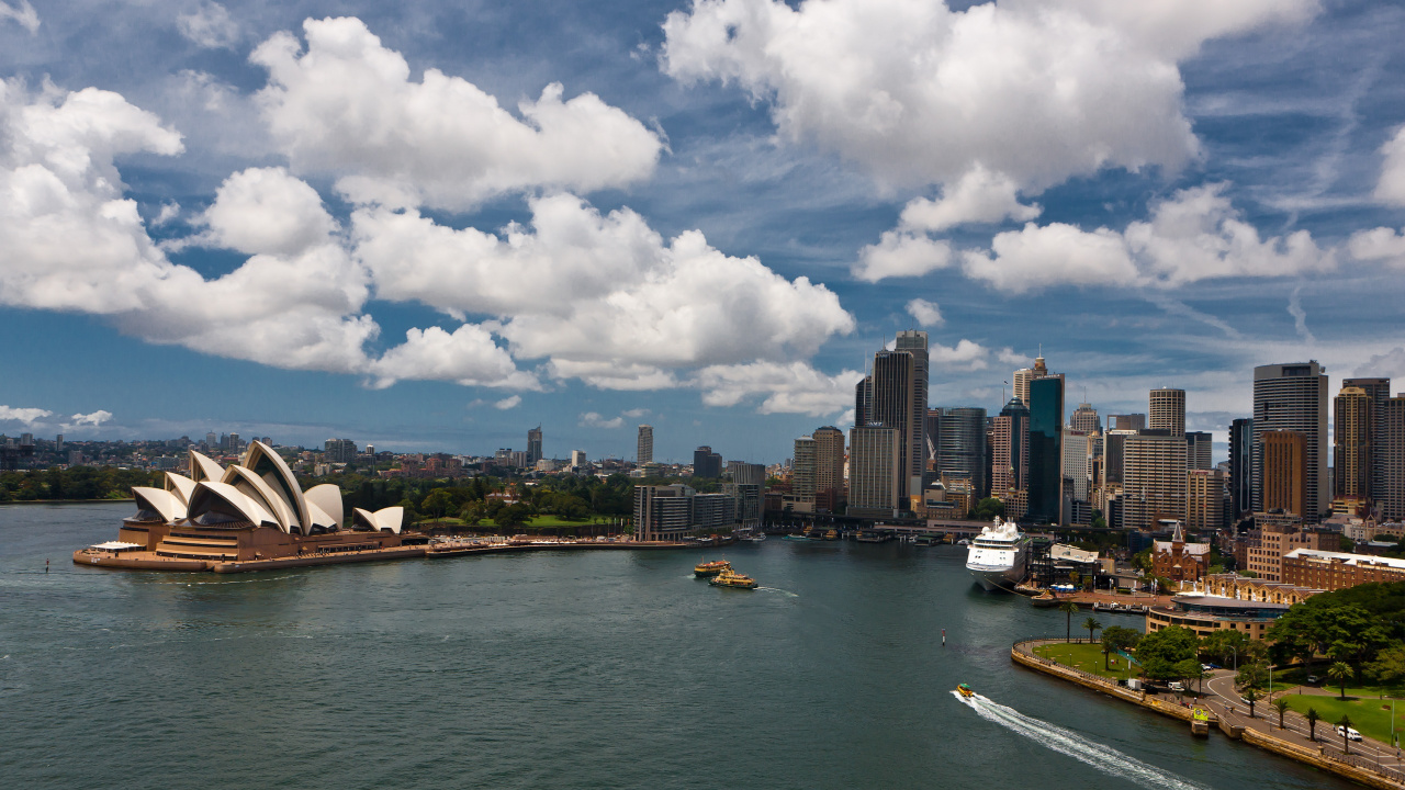White and Blue Boat on Sea Near City Buildings Under White Clouds and Blue Sky During. Wallpaper in 1280x720 Resolution