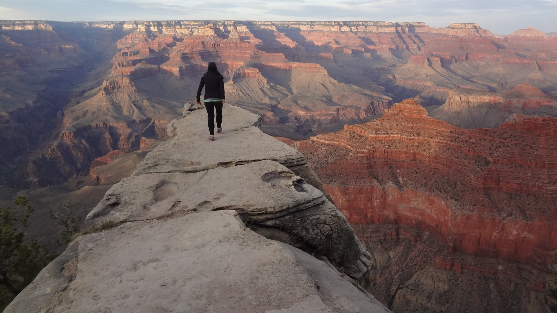 Man in Black Jacket Standing on Rock Formation During Daytime. Wallpaper in 1920x1080 Resolution