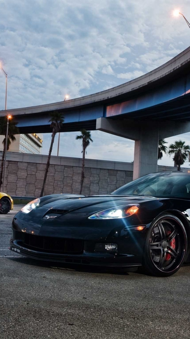 Black Porsche 911 Parked on Parking Lot. Wallpaper in 720x1280 Resolution