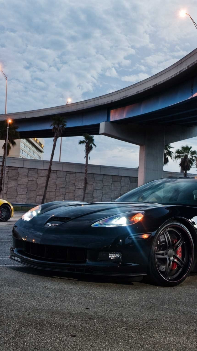 Porsche 911 Noire Garée Sur Parking. Wallpaper in 750x1334 Resolution