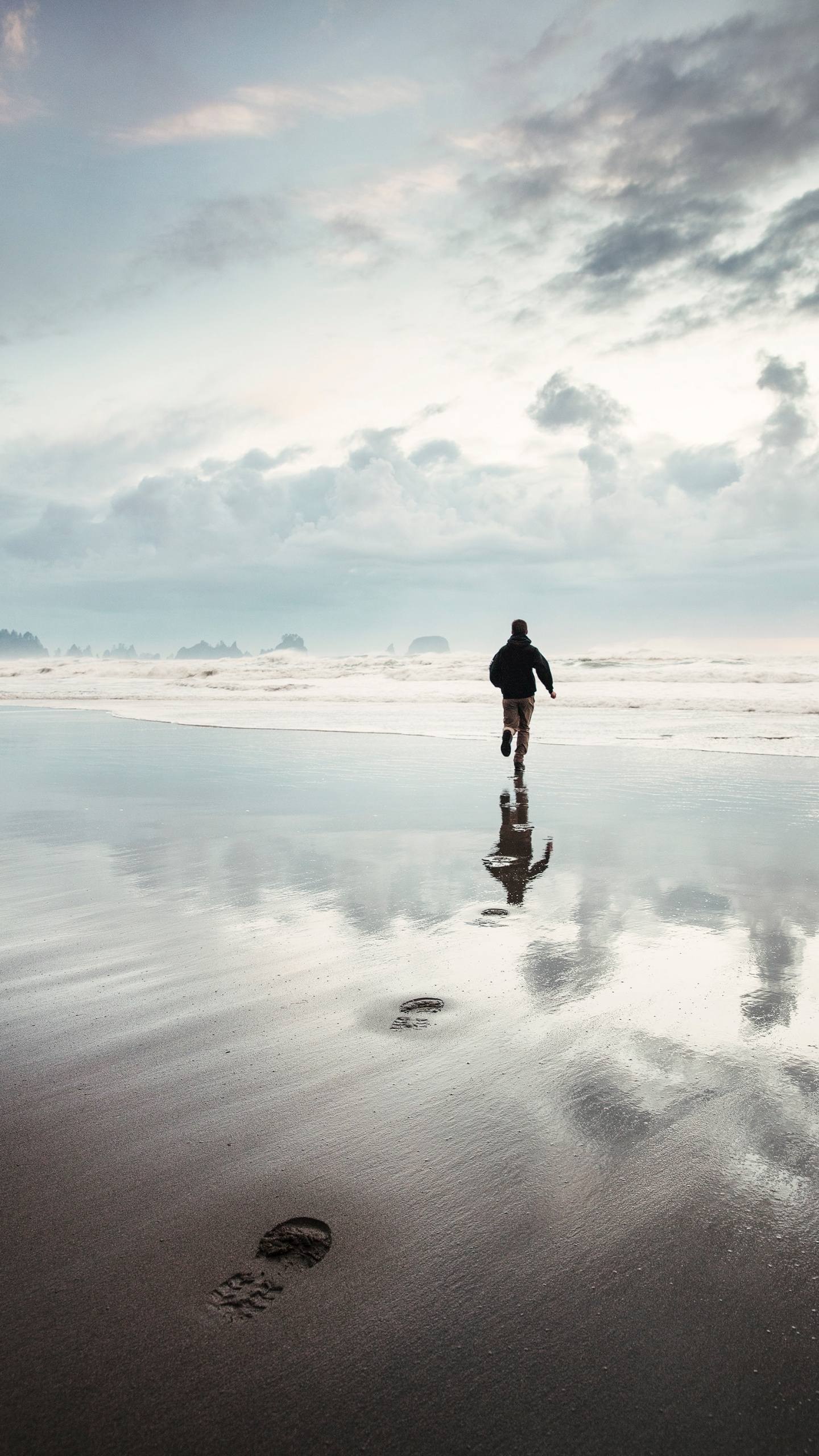 Man in Black Jacket Walking on Beach During Daytime. Wallpaper in 1440x2560 Resolution