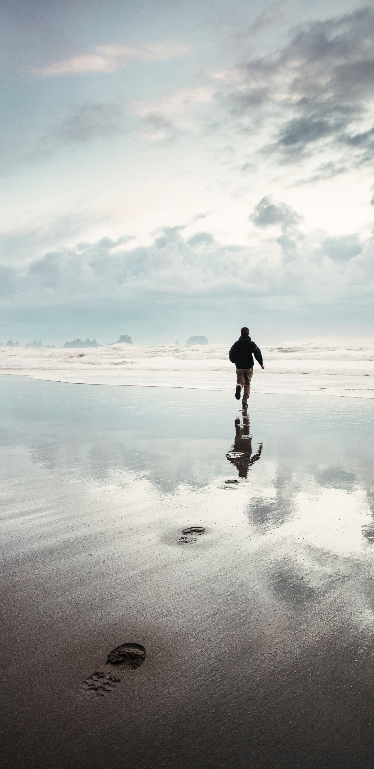 Man in Black Jacket Walking on Beach During Daytime. Wallpaper in 1440x2960 Resolution
