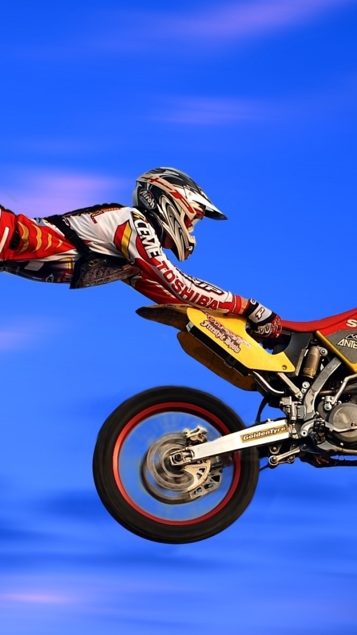 Man Riding Motocross Dirt Bike. Wallpaper in 720x1280 Resolution