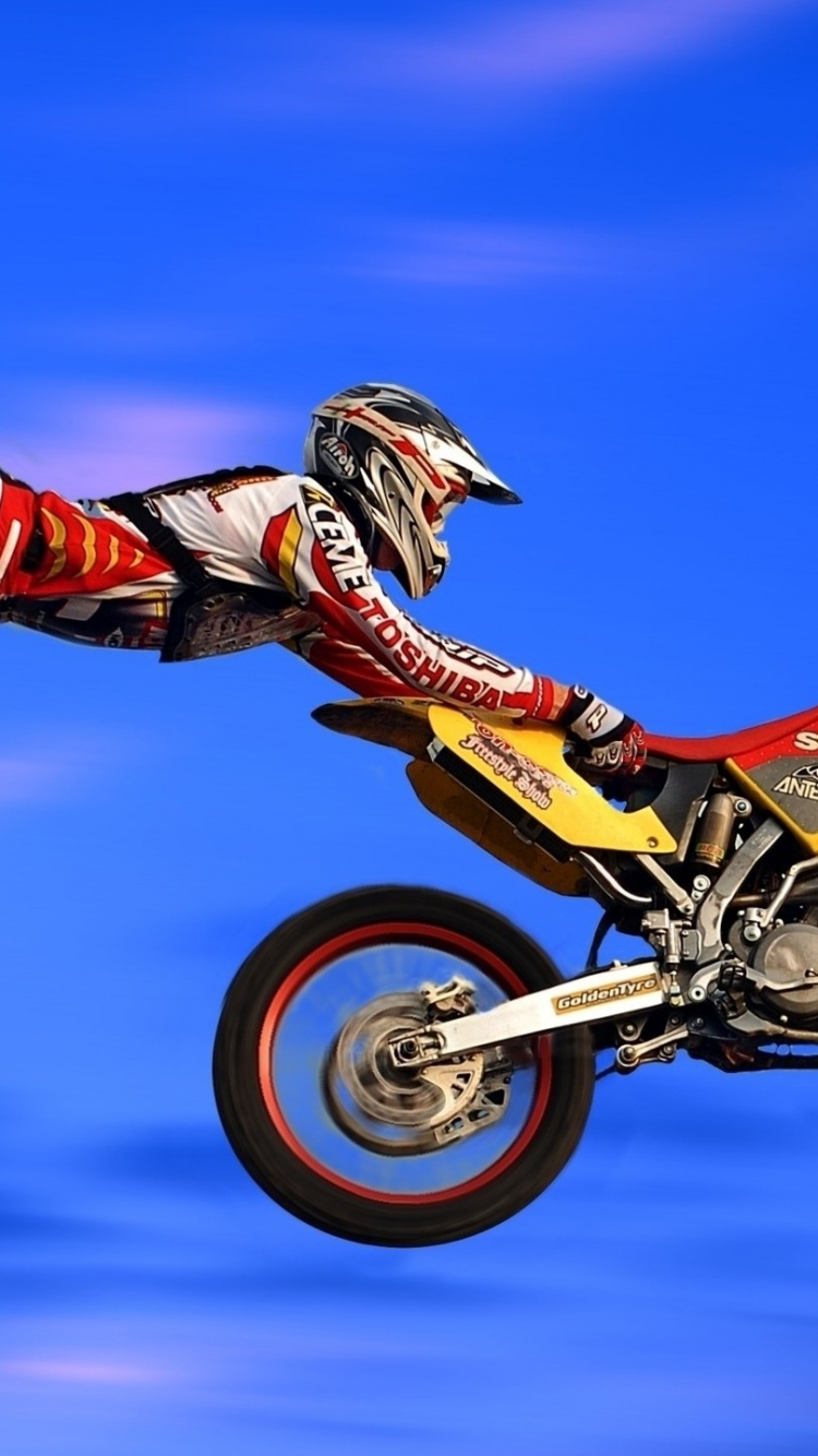 Man Riding Motocross Dirt Bike. Wallpaper in 750x1334 Resolution