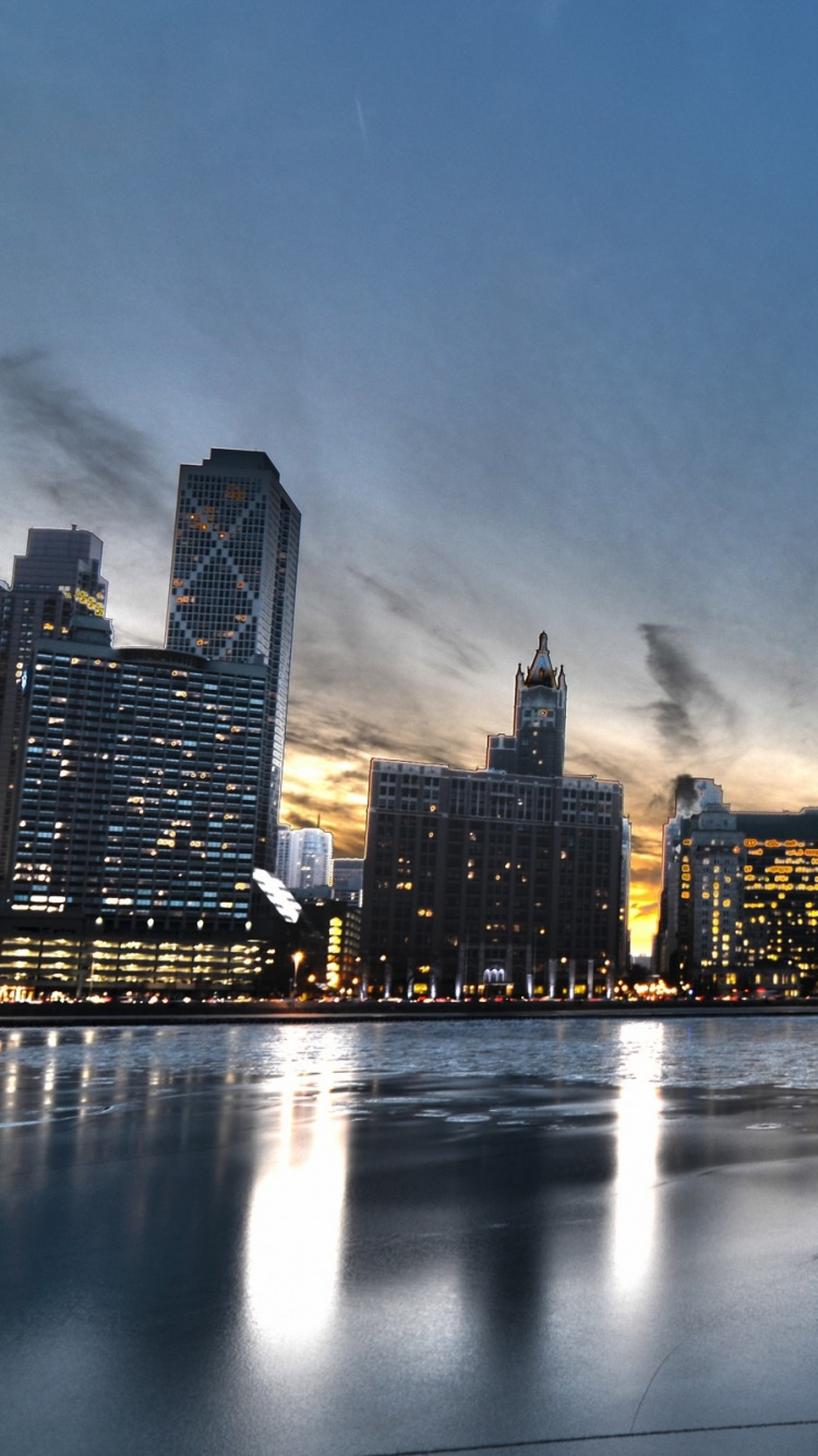 City Skyline Across Body of Water During Night Time. Wallpaper in 750x1334 Resolution