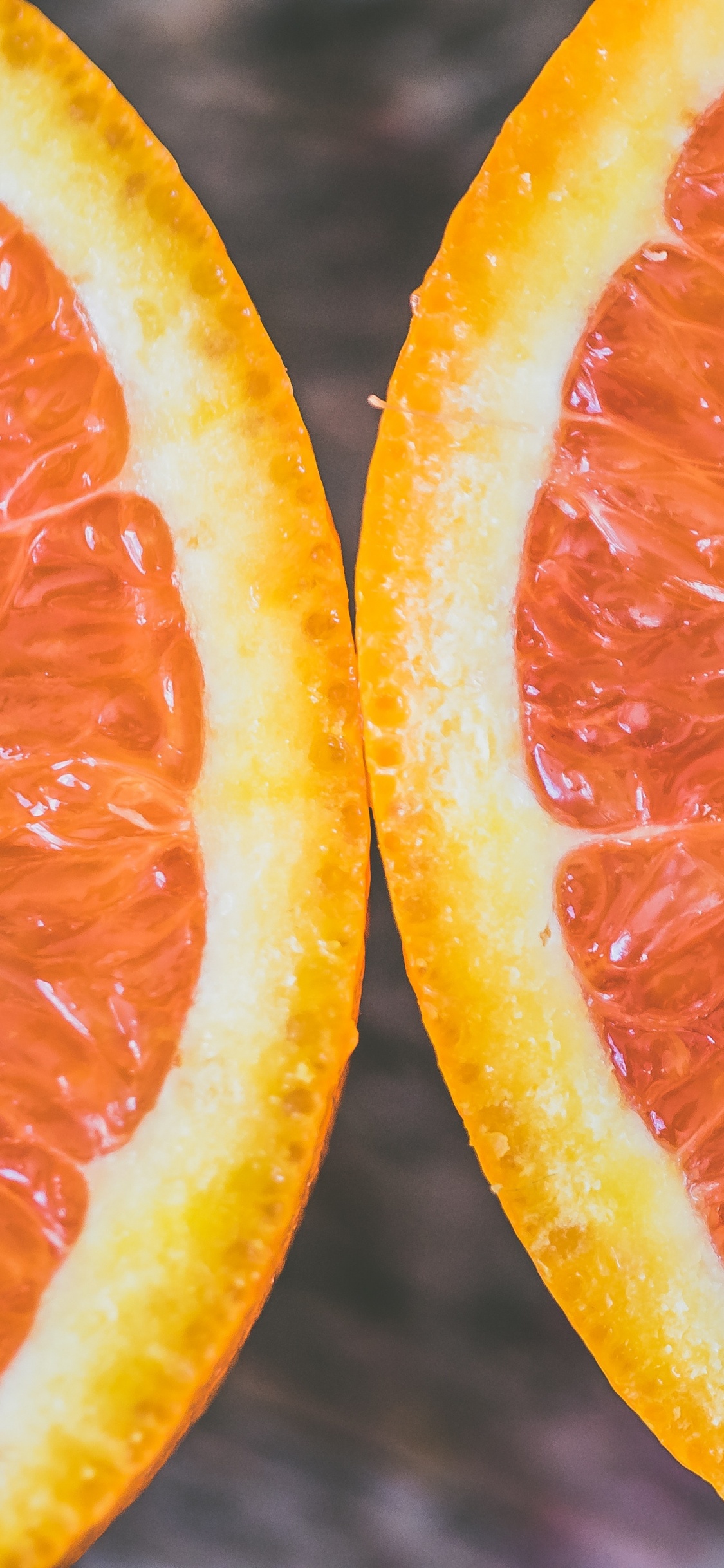 Sliced Orange Fruit in Close up Photography. Wallpaper in 1125x2436 Resolution