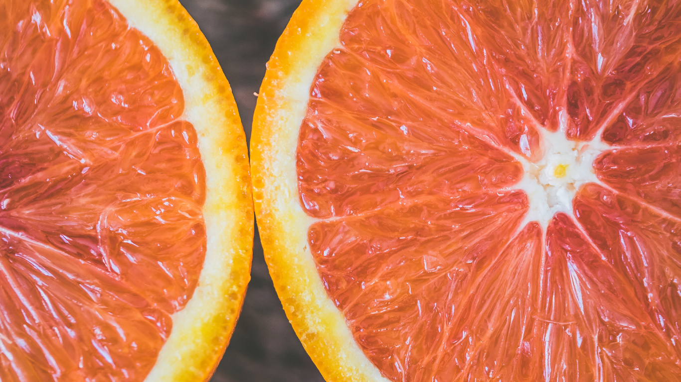 Sliced Orange Fruit in Close up Photography. Wallpaper in 1366x768 Resolution