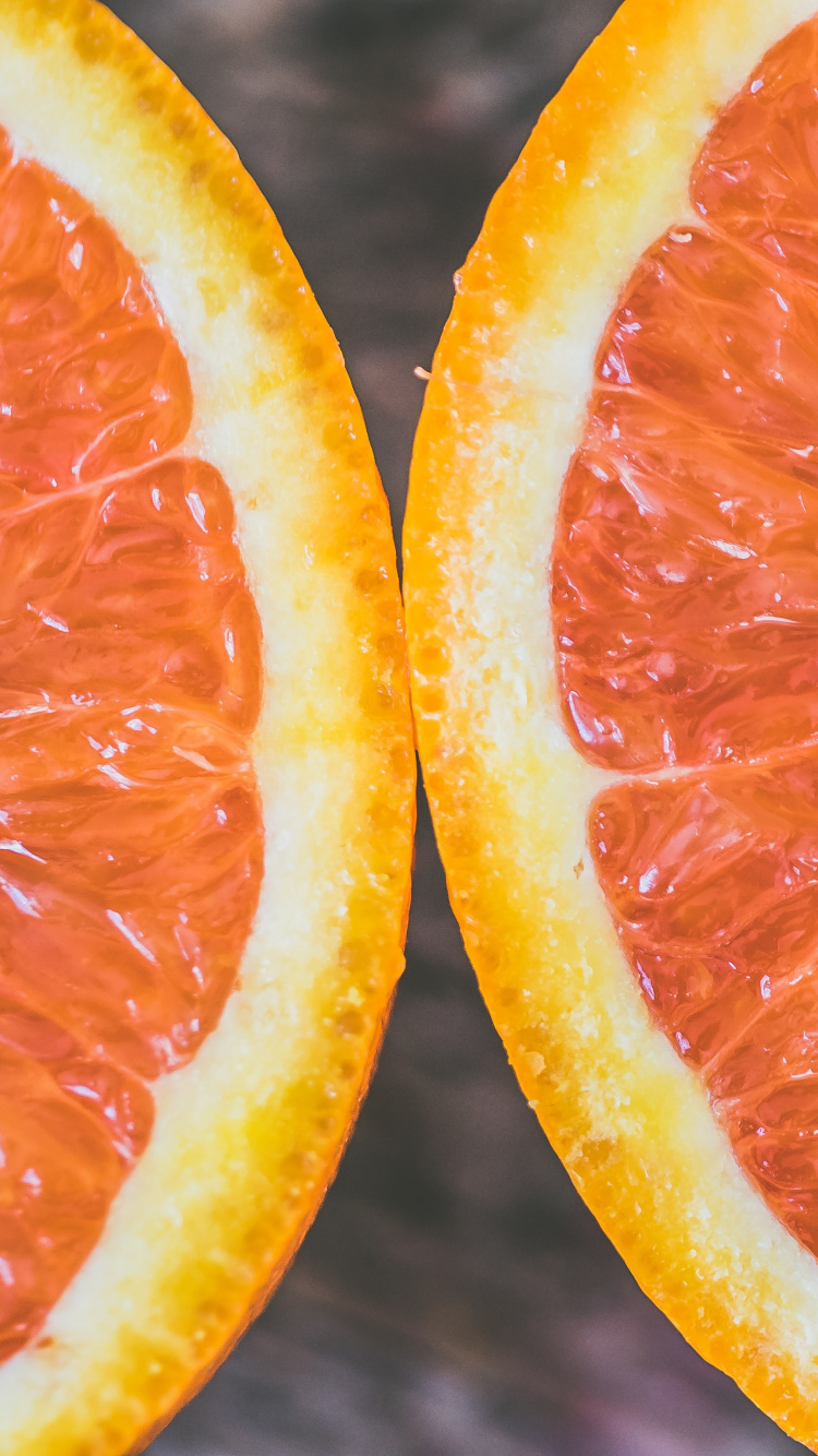 Sliced Orange Fruit in Close up Photography. Wallpaper in 750x1334 Resolution