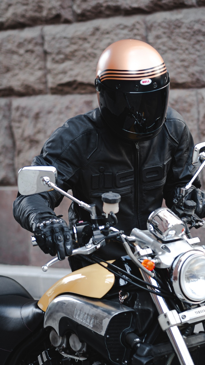 Man in Black Leather Jacket Wearing Black Helmet Riding Yellow Motorcycle. Wallpaper in 720x1280 Resolution
