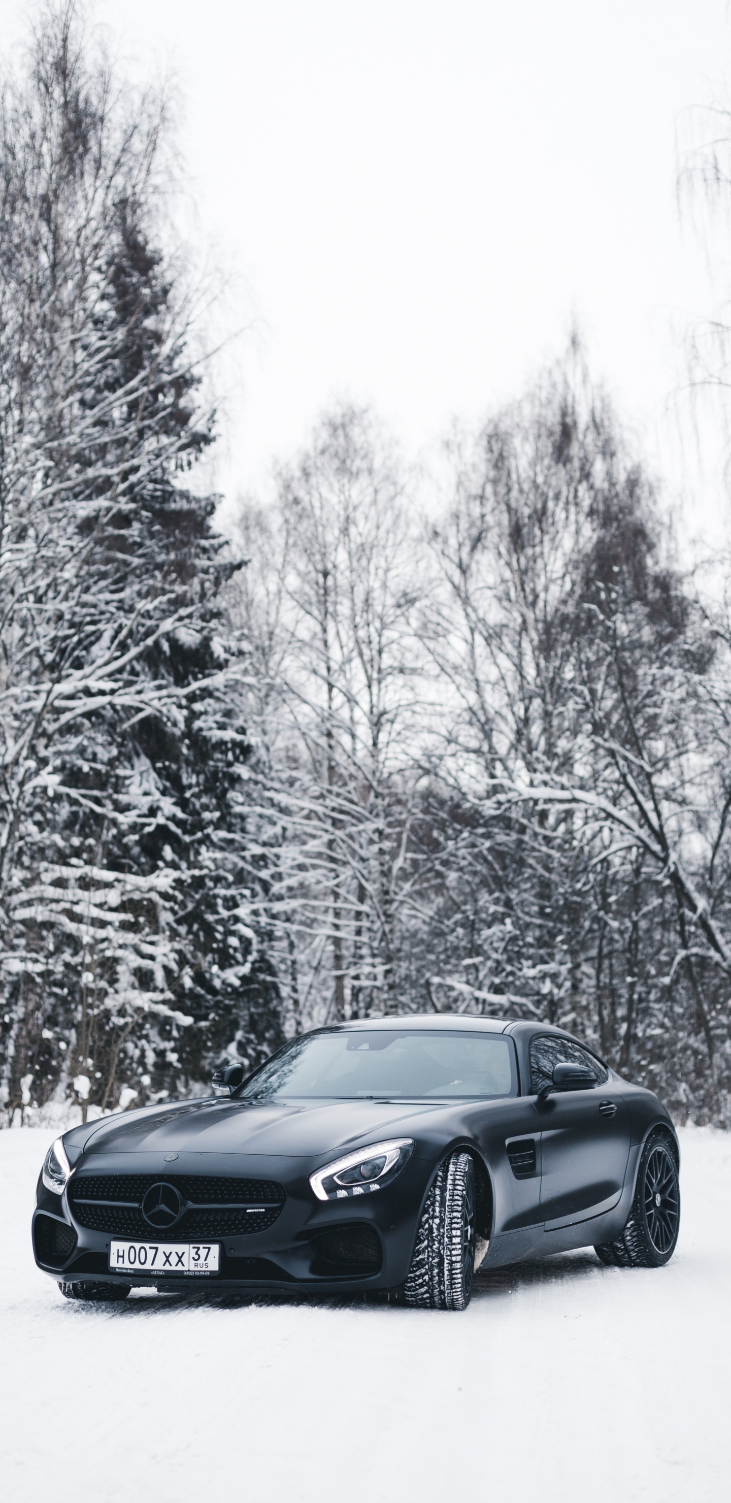 Black Bmw Coupe on Snow Covered Road During Daytime. Wallpaper in 1440x2960 Resolution