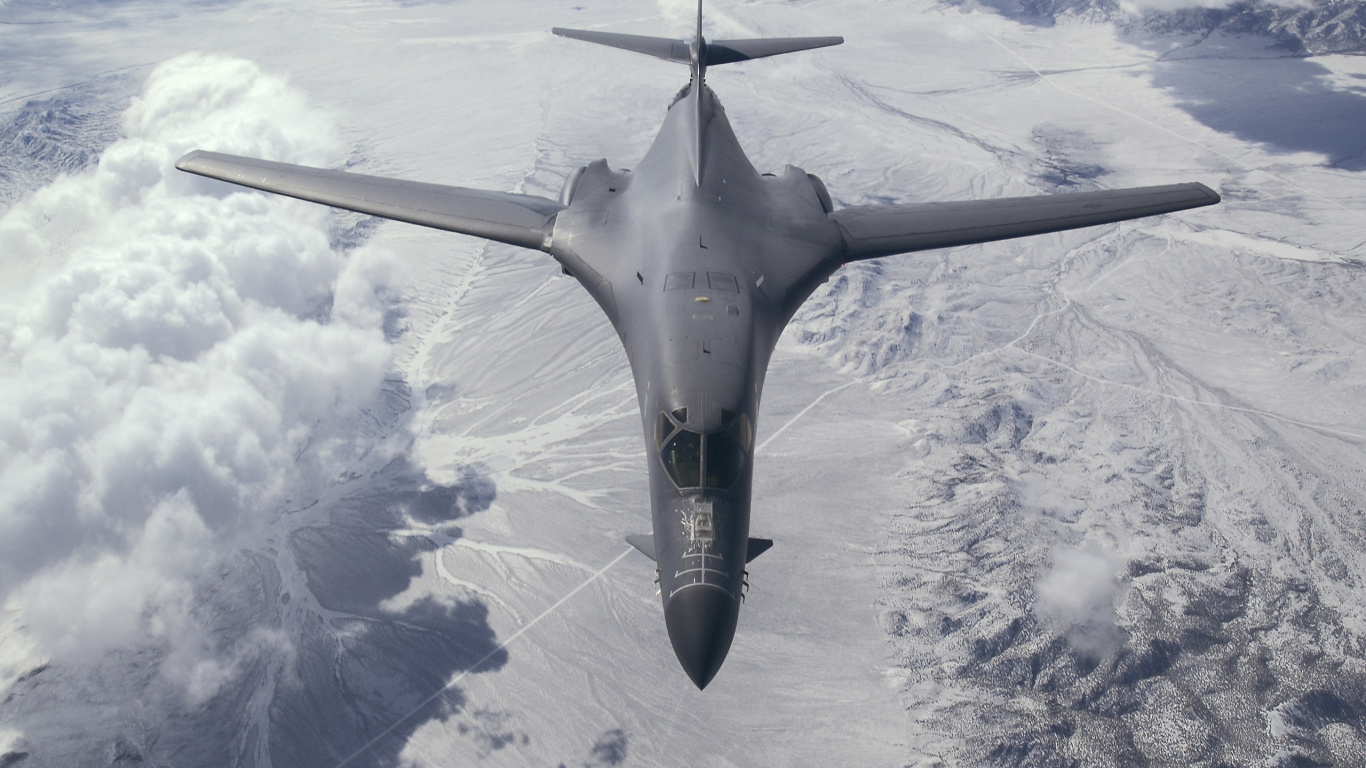 Gray Fighter Jet Flying Over White Clouds During Daytime. Wallpaper in 1366x768 Resolution