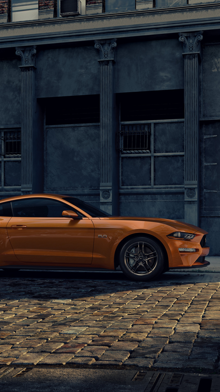 Voiture Orange Garée à Côté du Bâtiment. Wallpaper in 750x1334 Resolution