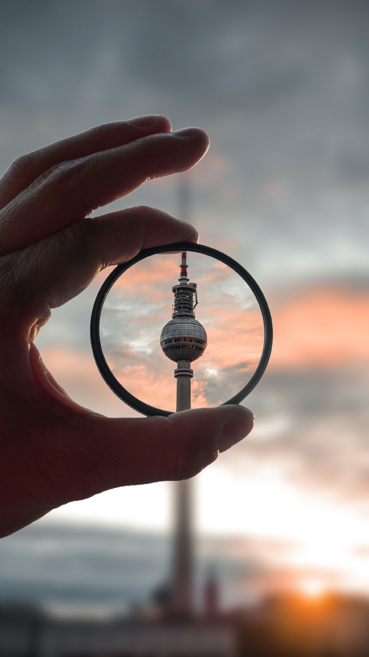 Person Holding Magnifying Glass During Sunset. Wallpaper in 720x1280 Resolution