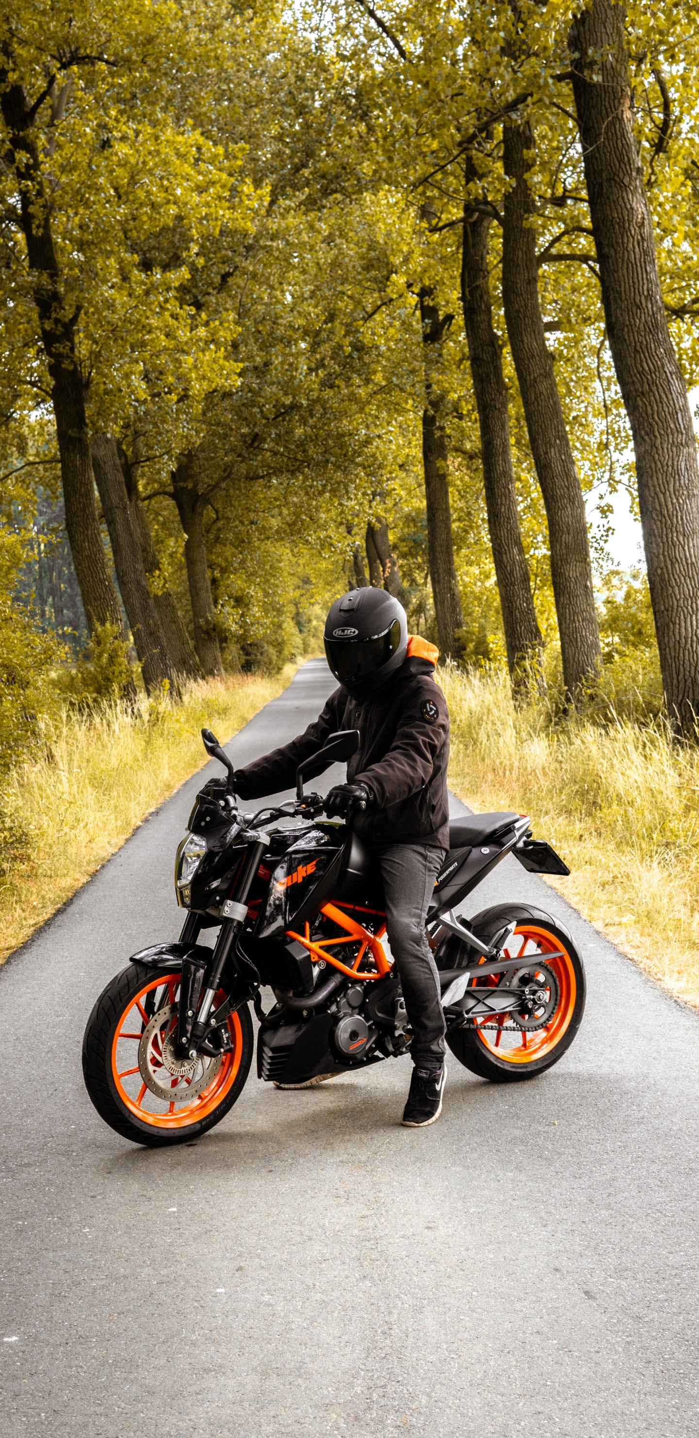 Man in Black Jacket Riding Black Motorcycle on Road During Daytime. Wallpaper in 1440x2960 Resolution