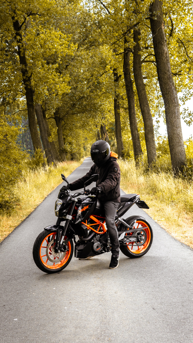 Man in Black Jacket Riding Black Motorcycle on Road During Daytime. Wallpaper in 750x1334 Resolution