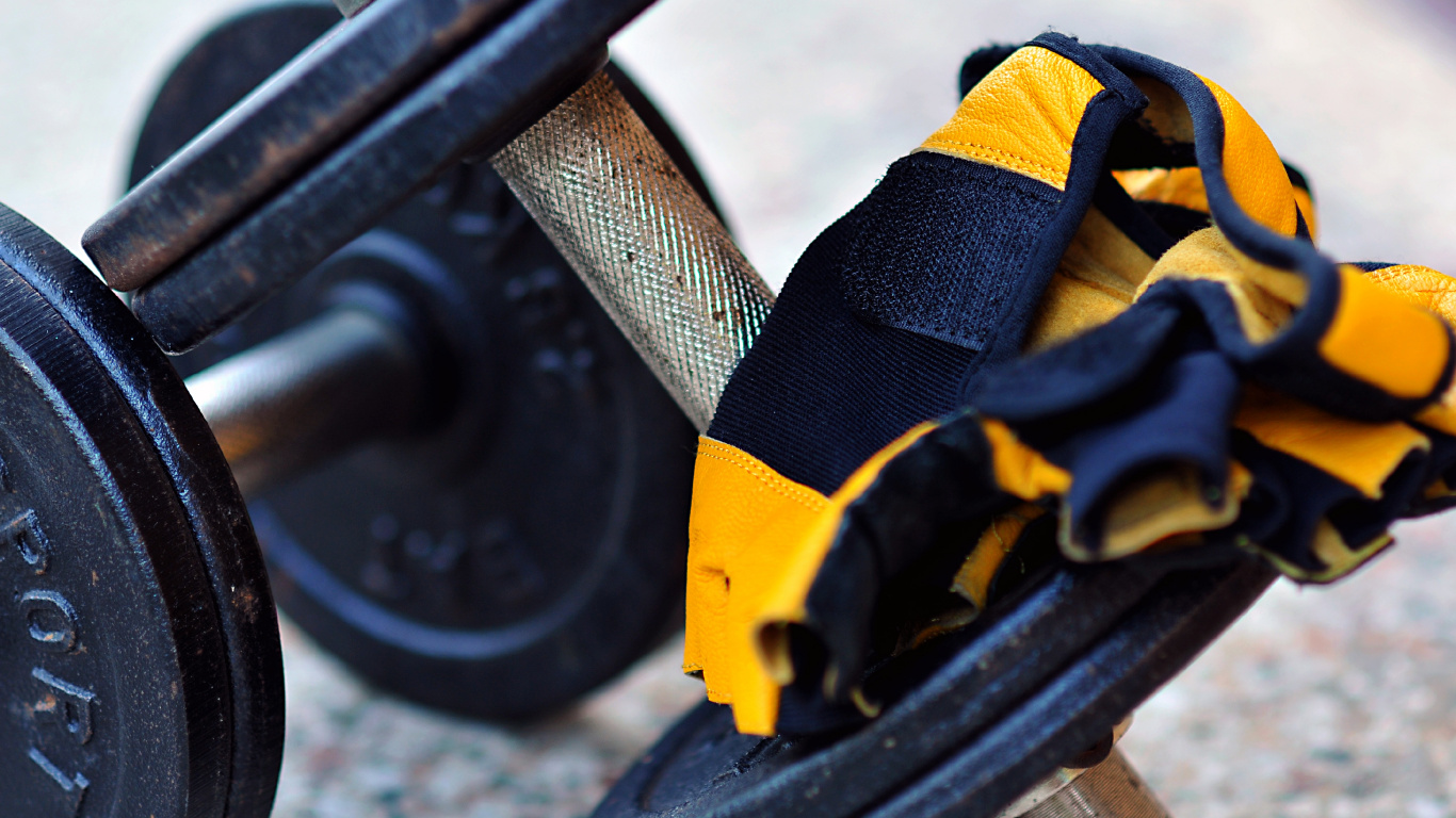 Black and Yellow Dumbbell on Gray Concrete Floor. Wallpaper in 1366x768 Resolution