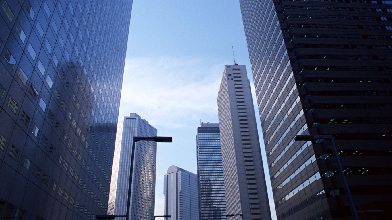 White and Blue High Rise Buildings Under Blue Sky During Daytime. Wallpaper in 1366x768 Resolution