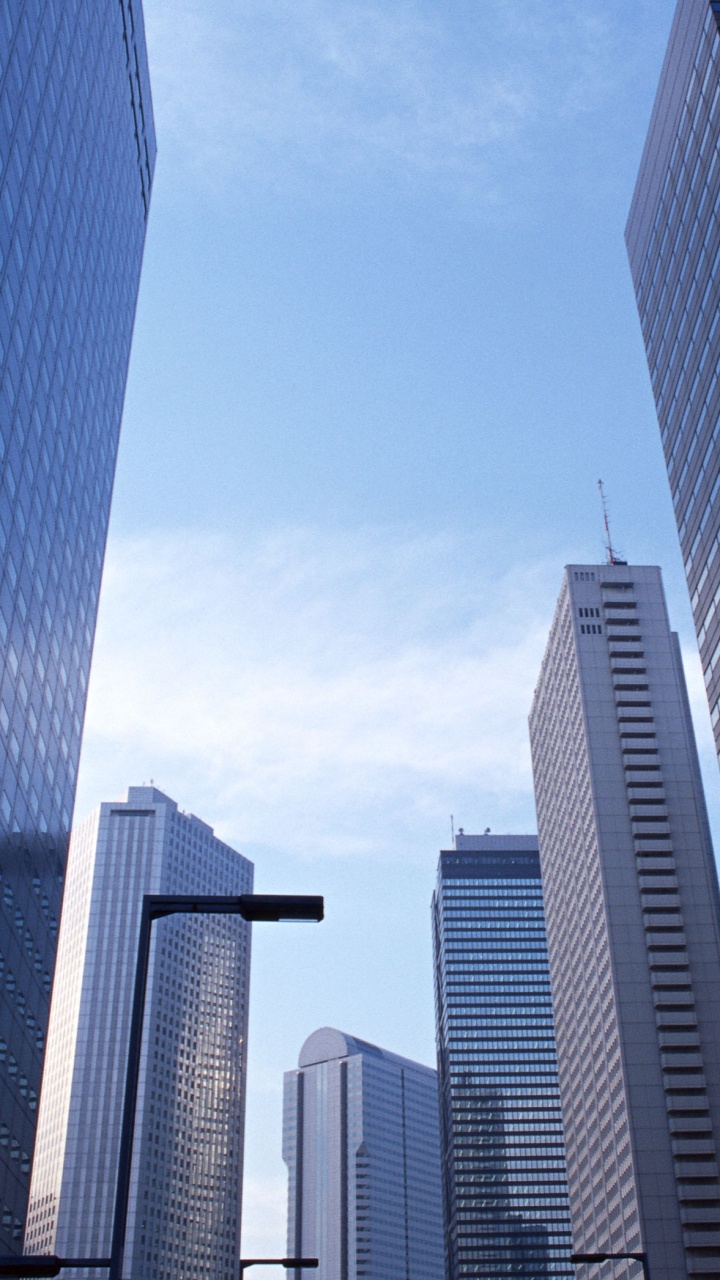 White and Blue High Rise Buildings Under Blue Sky During Daytime. Wallpaper in 720x1280 Resolution