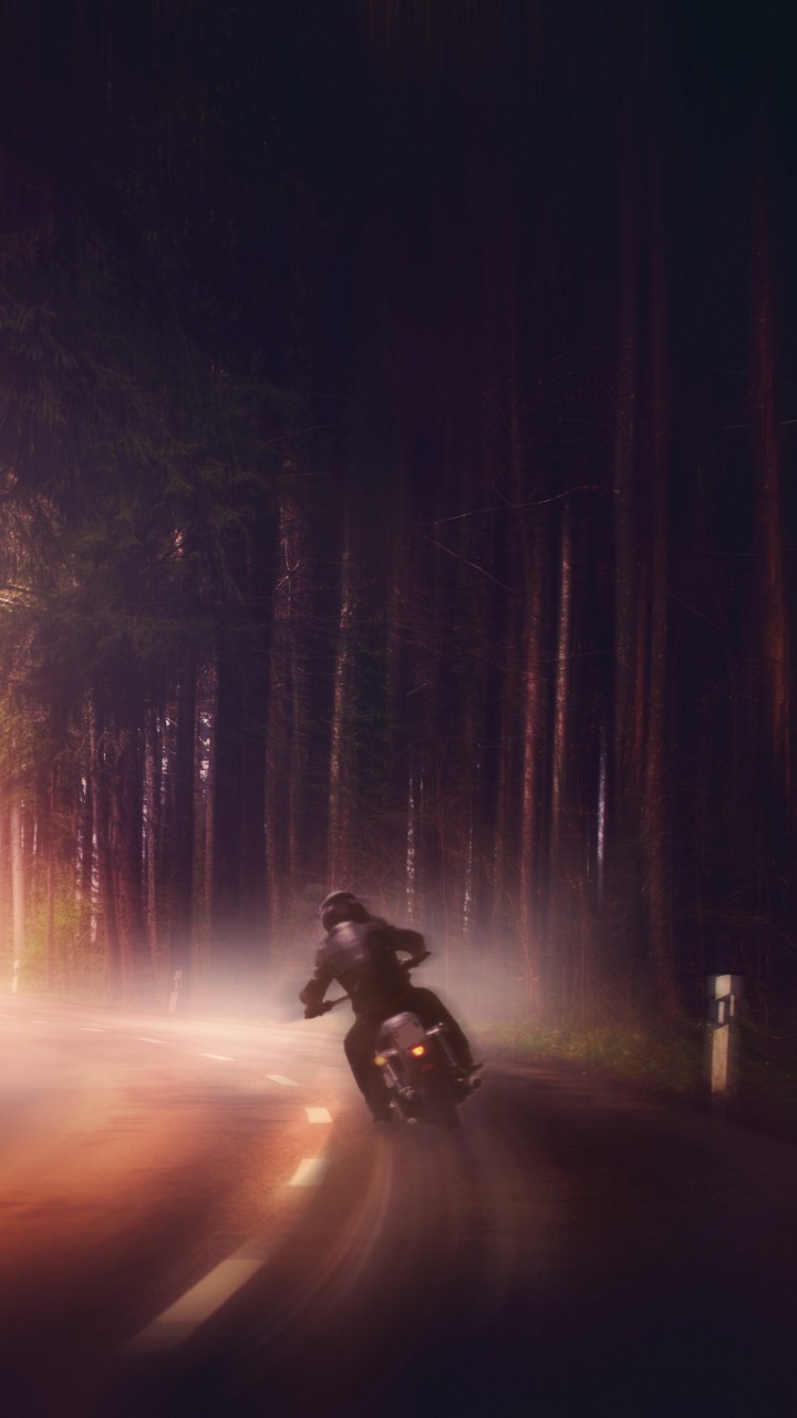 Person Riding Motorcycle on Road During Night Time. Wallpaper in 720x1280 Resolution