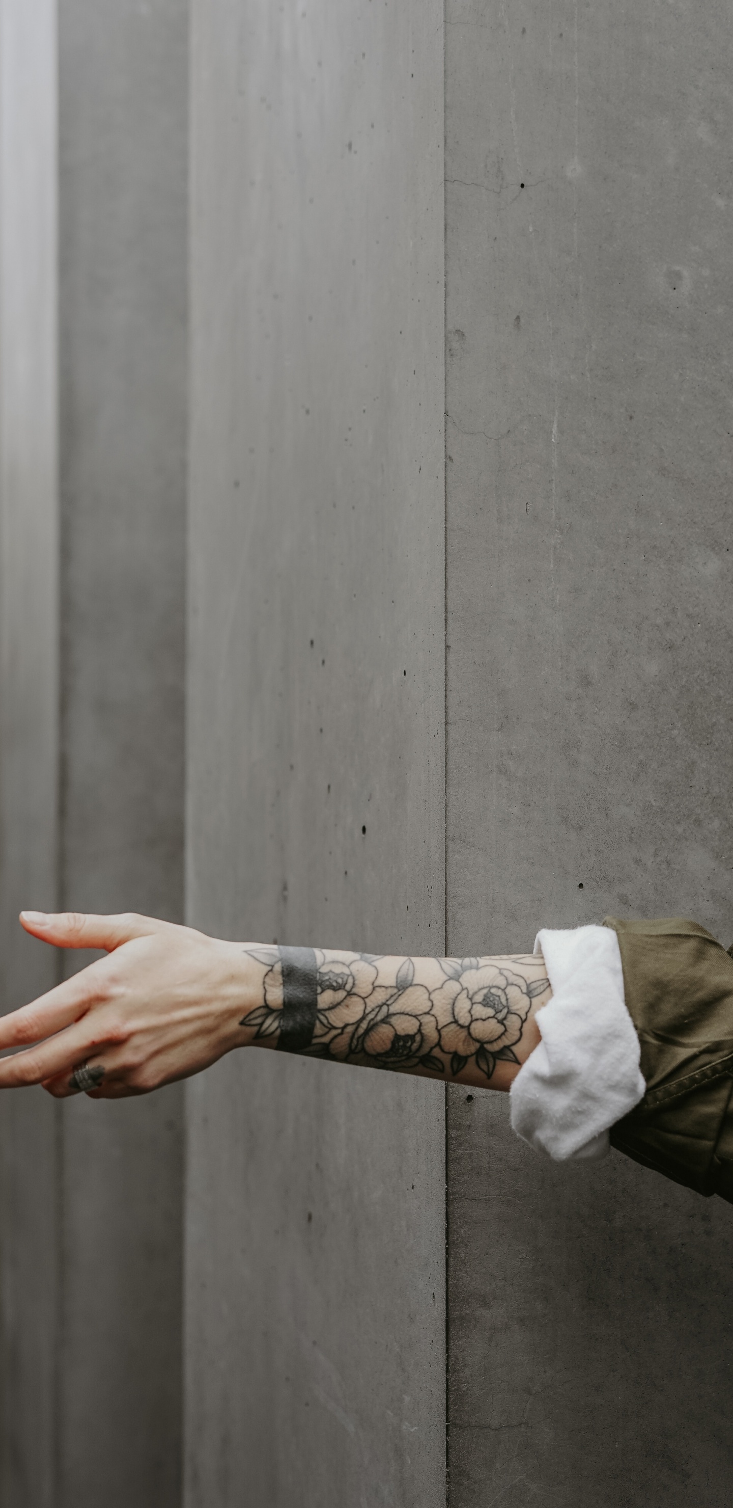 Person in Brown Jacket With Black Tattoo on Left Hand. Wallpaper in 1440x2960 Resolution