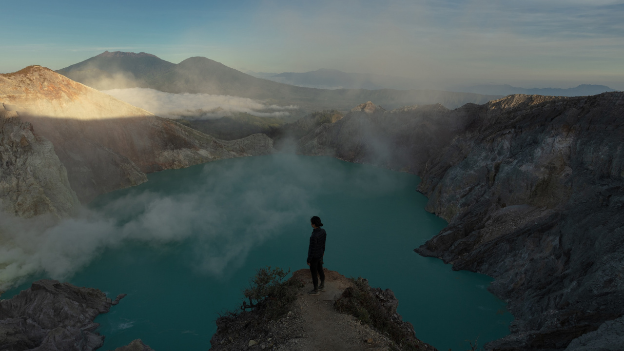 Person Standing on Rock Near Lake During Daytime. Wallpaper in 1280x720 Resolution