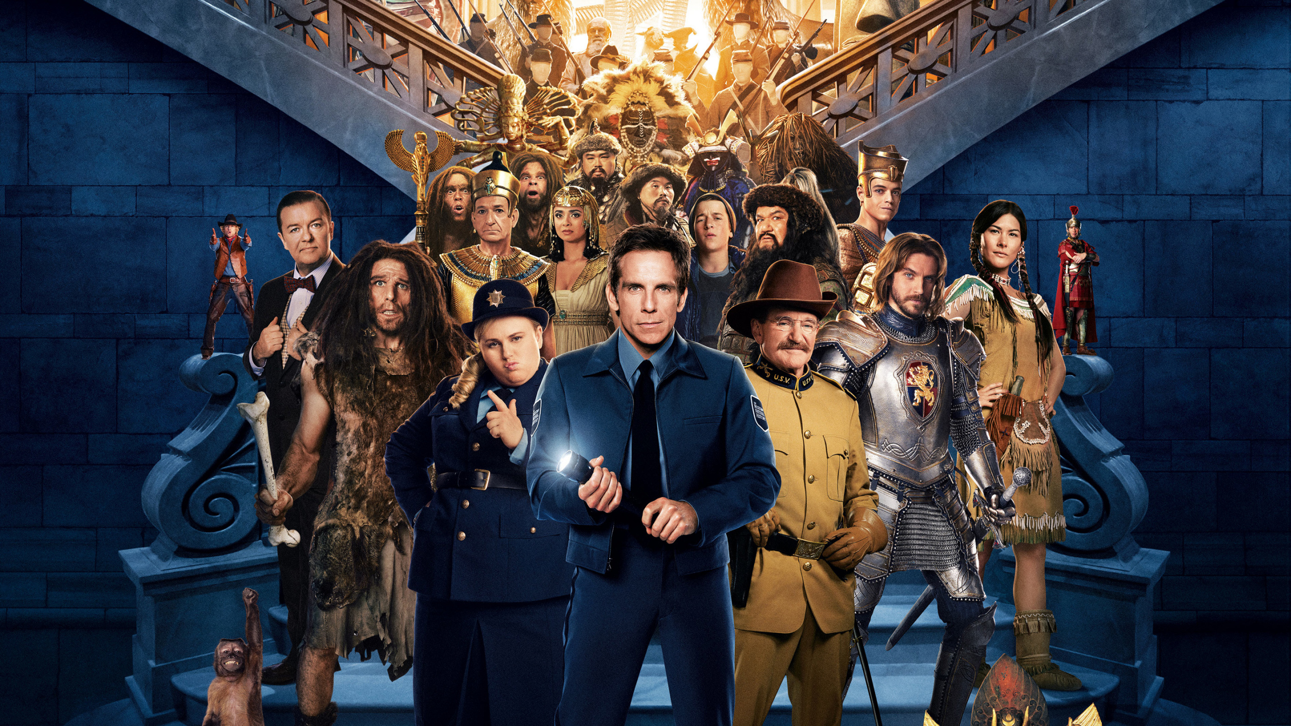 Woman in Black Long Sleeve Dress Standing Beside Man in Gold Costume. Wallpaper in 2560x1440 Resolution