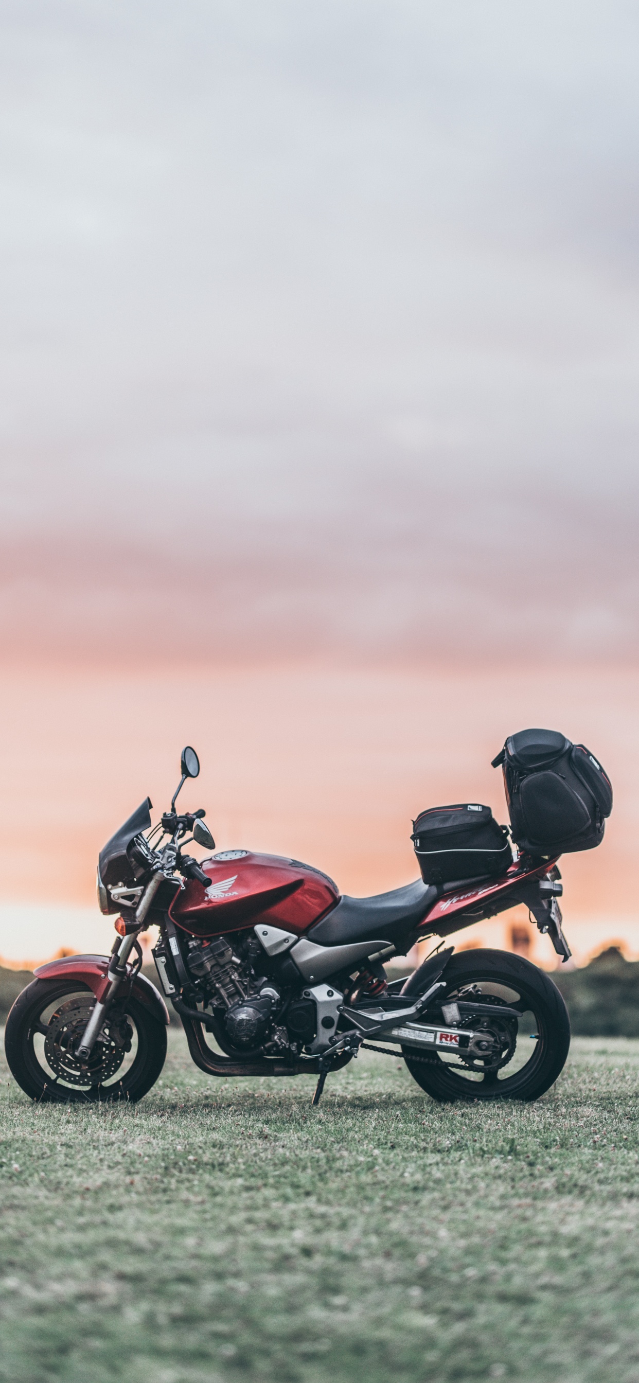 Black and Red Motorcycle on Green Grass Field During Daytime. Wallpaper in 1242x2688 Resolution