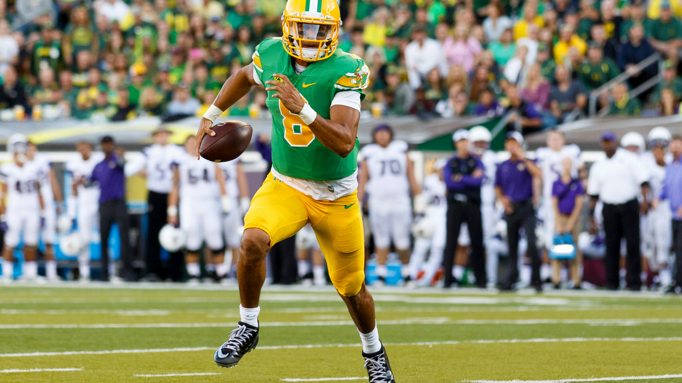 Football Player in Yellow Jersey Shirt and Blue Shorts Running on Field During Daytime. Wallpaper in 1366x768 Resolution