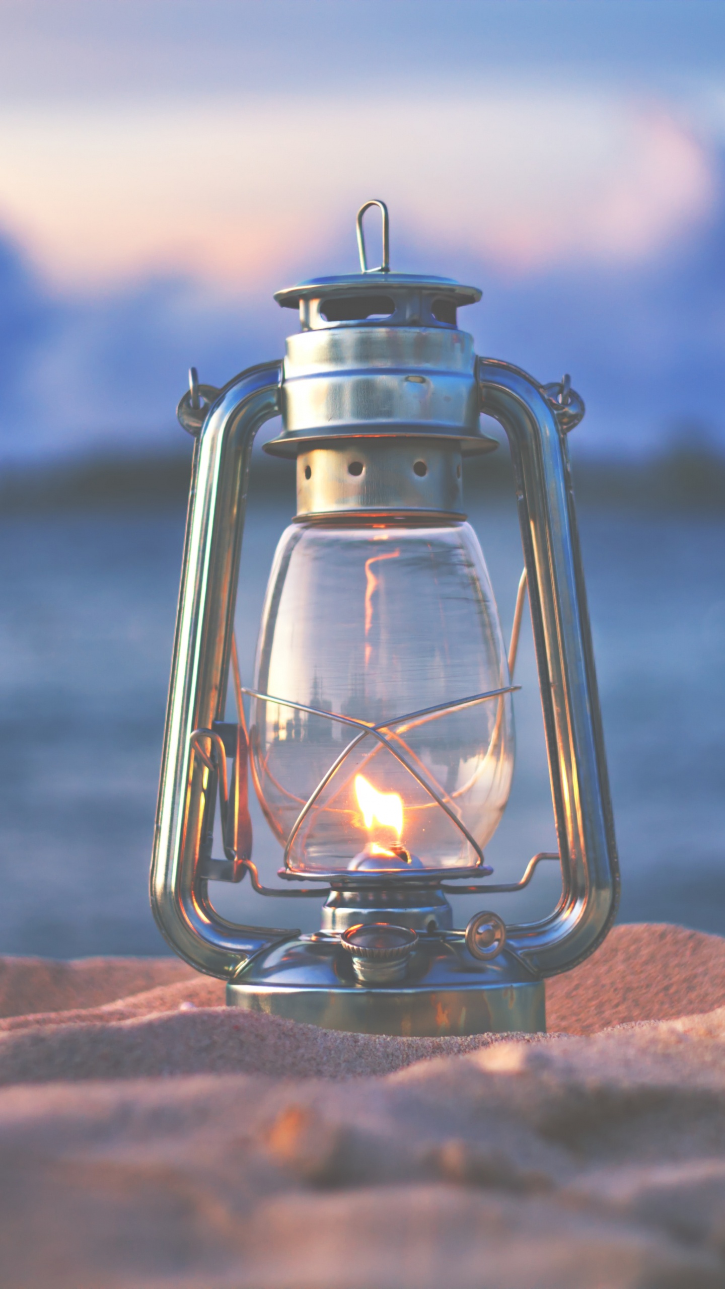 Clear Glass Candle Lantern on Brown Rock. Wallpaper in 1440x2560 Resolution