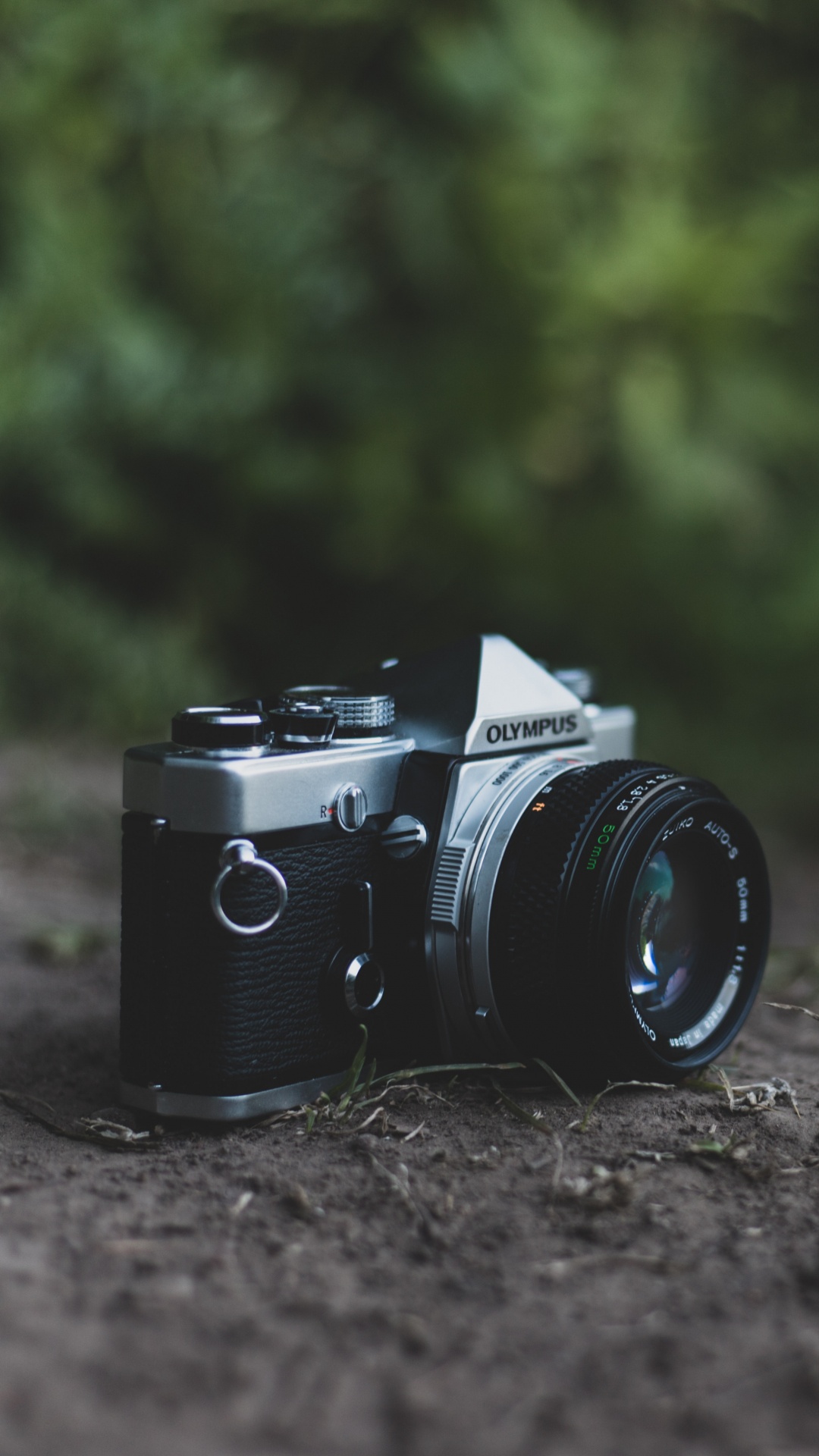 Schwarze Und Silberne DSLR-Kamera Auf Grünem Gras. Wallpaper in 1080x1920 Resolution