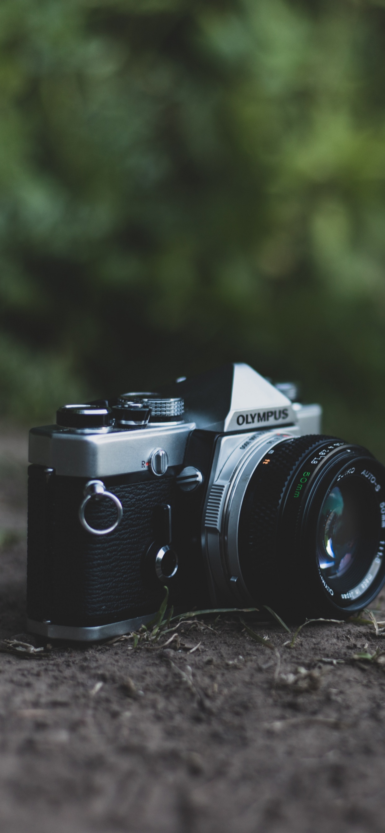 Black and Silver Dslr Camera on Green Grass. Wallpaper in 1242x2688 Resolution