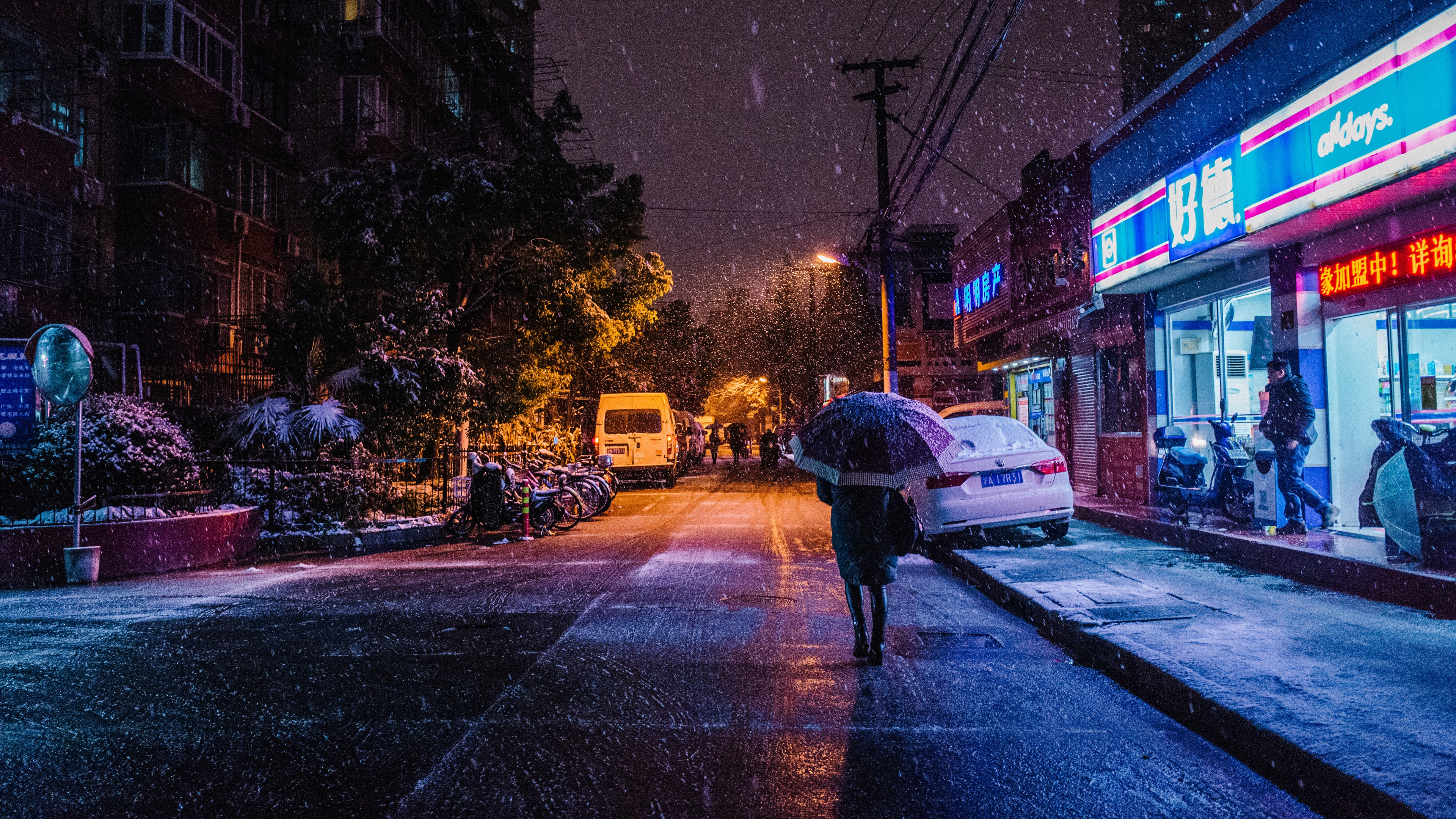 Person in Black Jacket and Black Pants Walking on Sidewalk During Night Time. Wallpaper in 3840x2160 Resolution