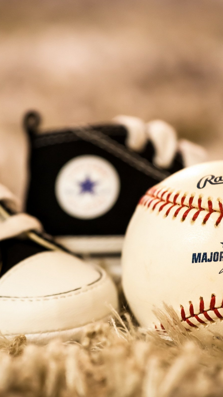 White and Red Baseball on Brown Grass. Wallpaper in 750x1334 Resolution