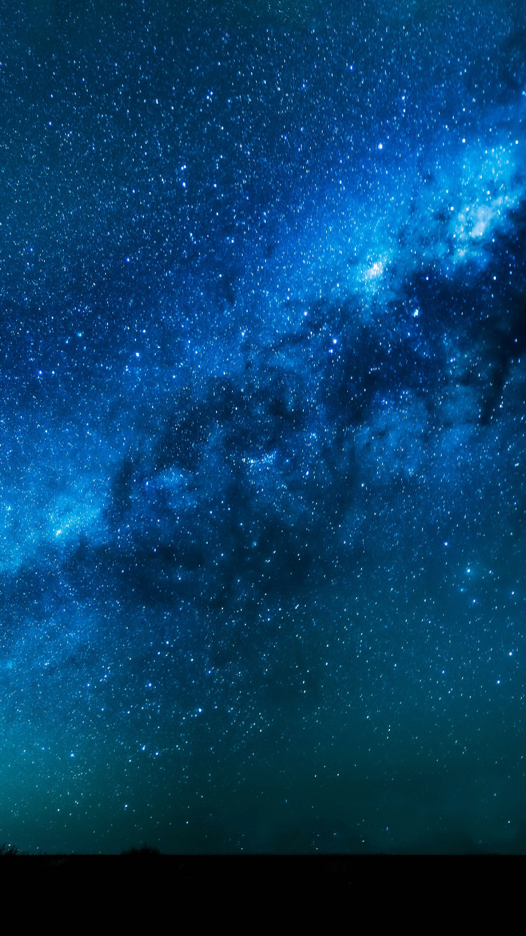 Silhouette of Person Standing Under Starry Night. Wallpaper in 750x1334 Resolution