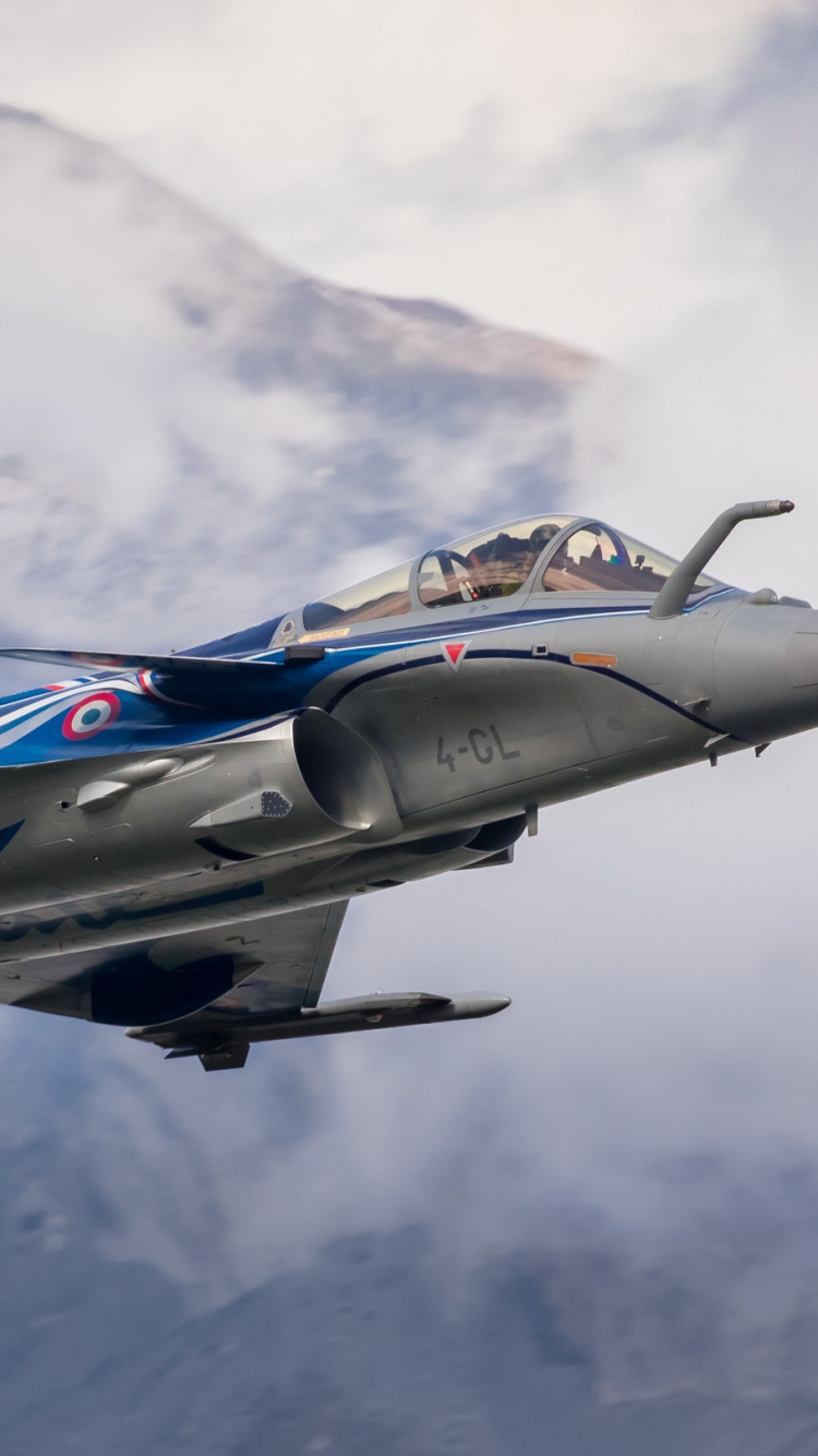 Blue and White Jet Plane Flying Over The Mountain. Wallpaper in 750x1334 Resolution