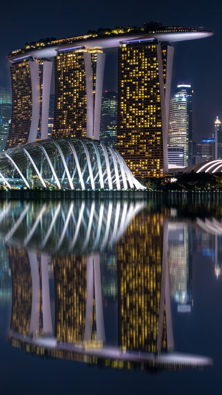 Body of Water Near High Rise Building During Night Time. Wallpaper in 720x1280 Resolution