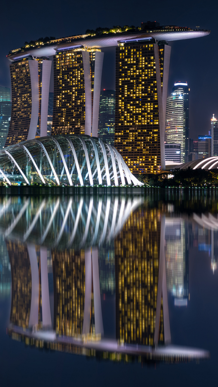 Body of Water Near High Rise Building During Night Time. Wallpaper in 750x1334 Resolution