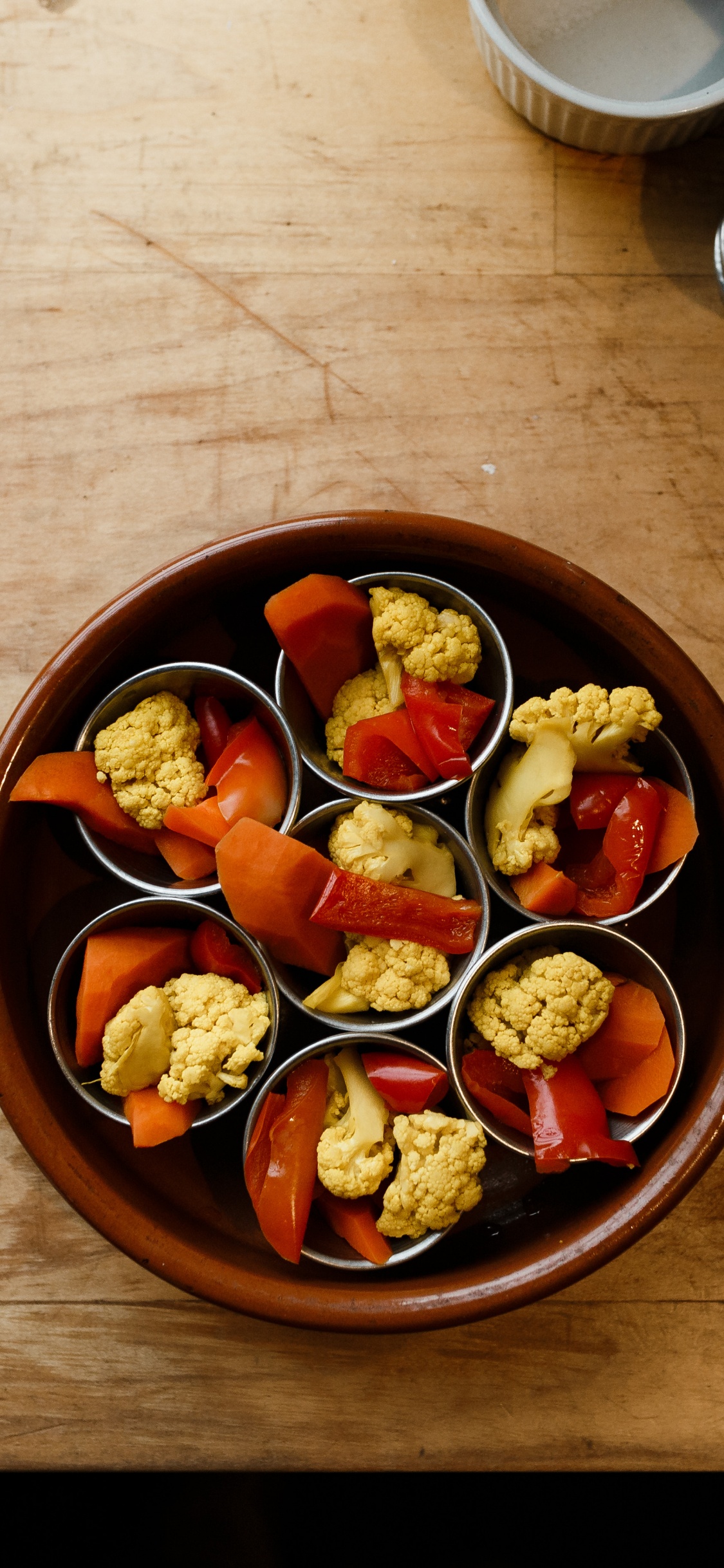 Sliced Fruits in Brown Bowl. Wallpaper in 1125x2436 Resolution