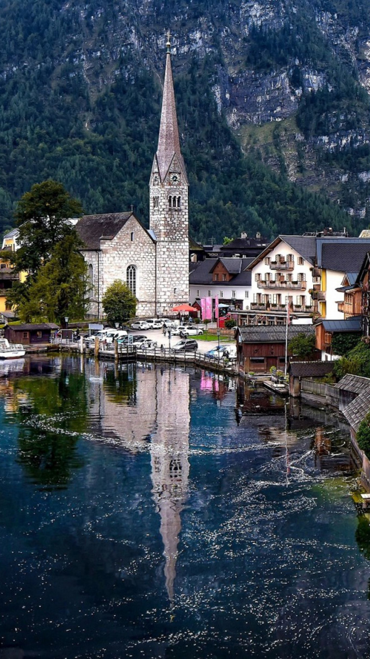 Brown and White Concrete Building Beside River During Daytime. Wallpaper in 750x1334 Resolution