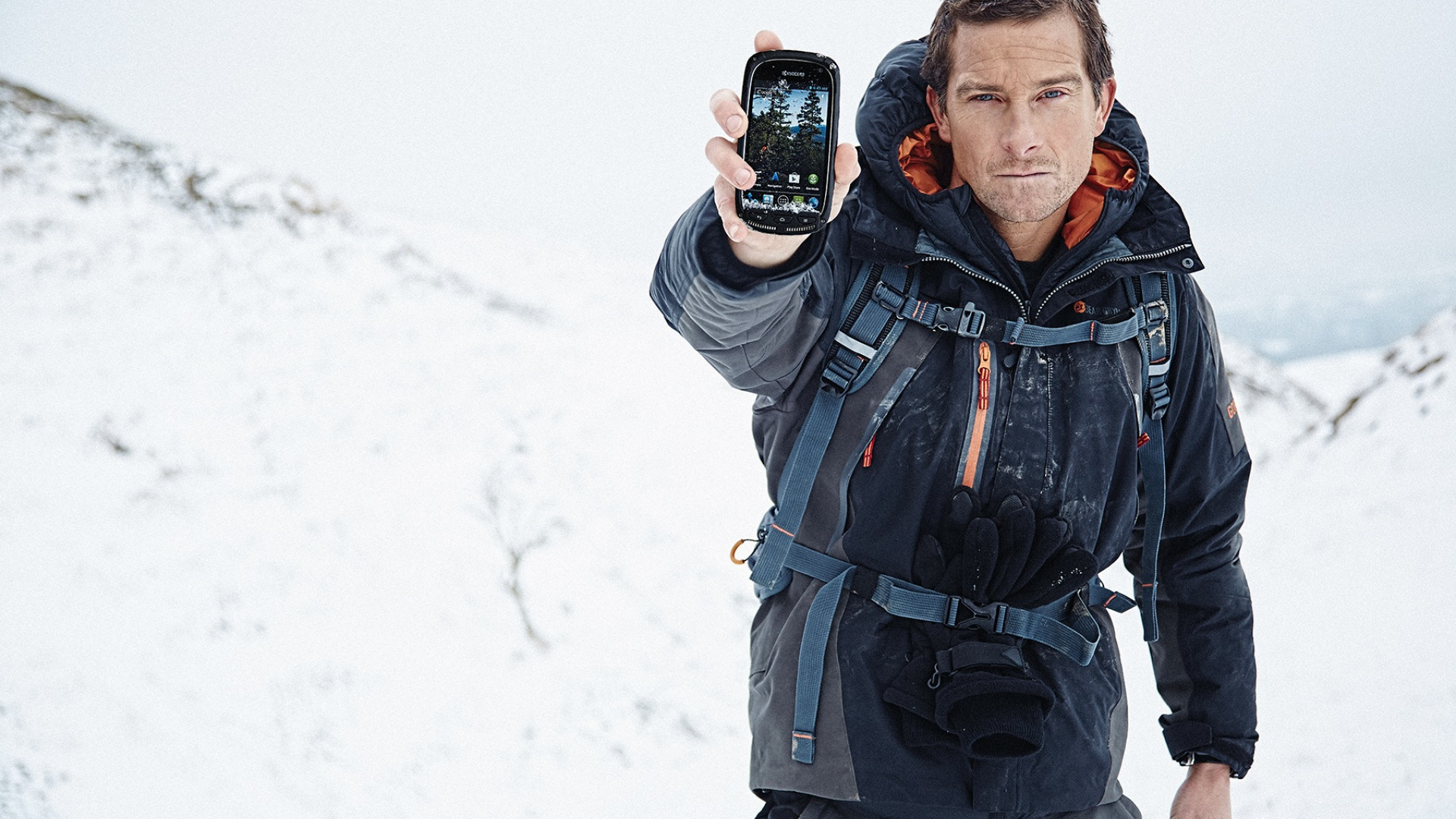 Man in Black and Red Zip up Jacket Holding Black Smartphone. Wallpaper in 1920x1080 Resolution